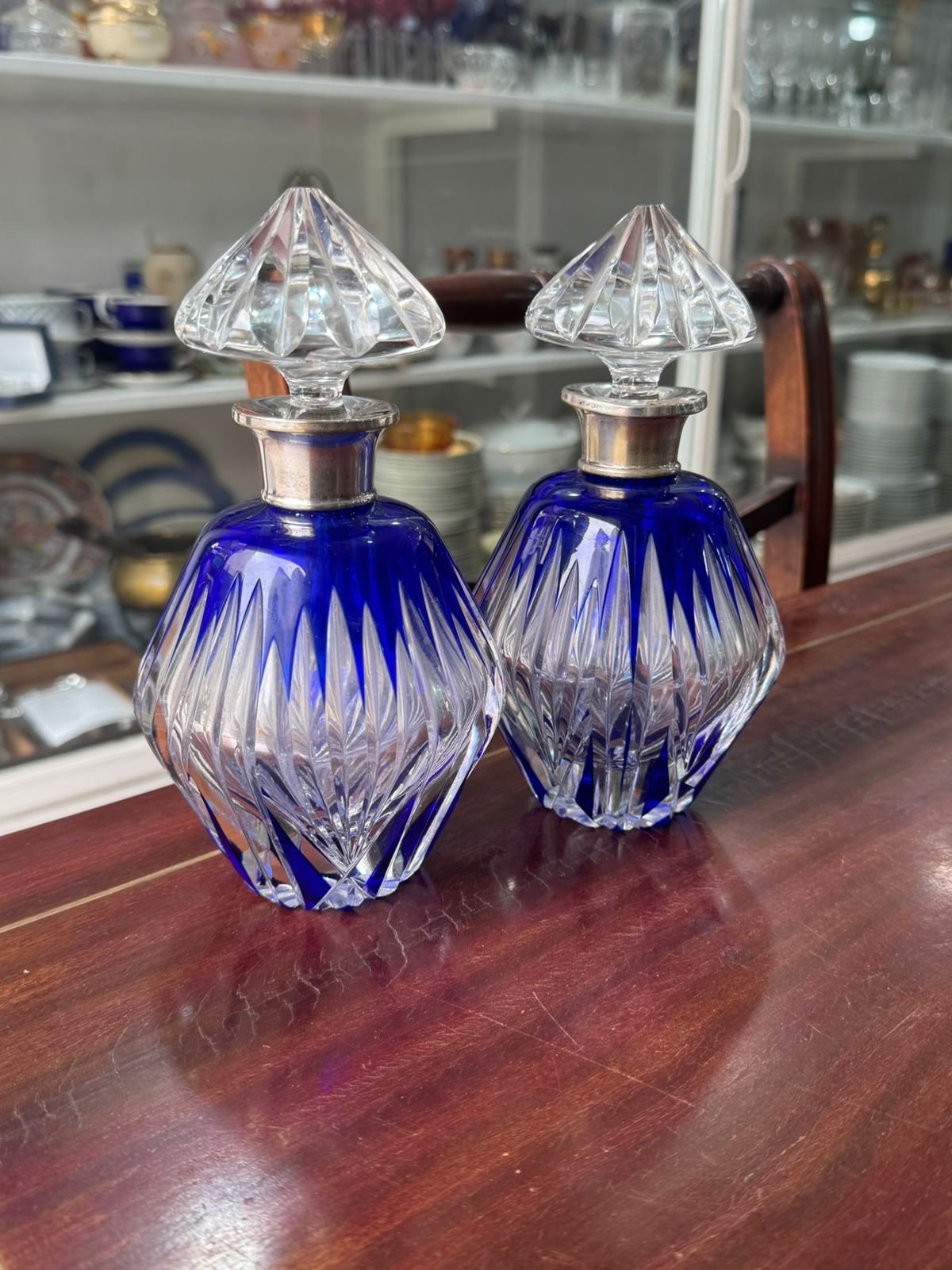 Par de botellones o perfumeros de cristal tallado azul con el pico de plateria